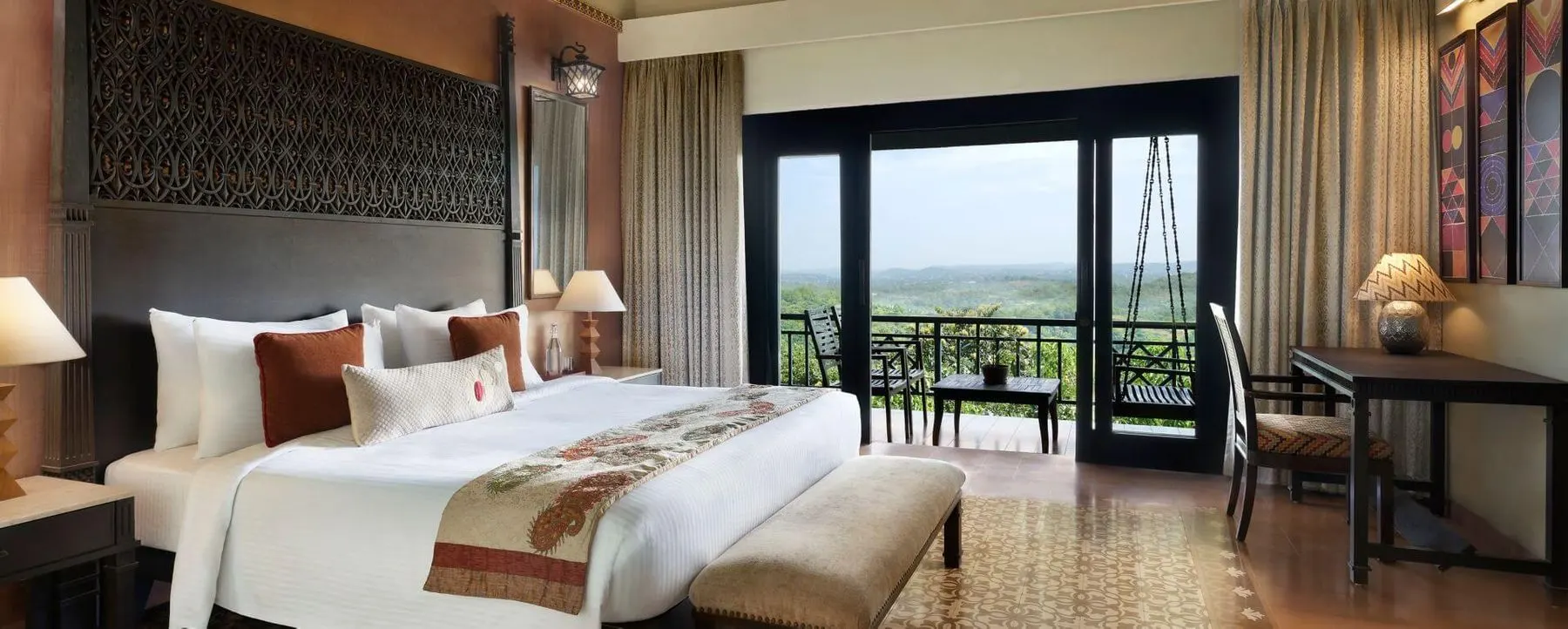 A spacious room with a forest-view balcony at a Dapoli hill resort
